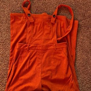 cider corduroy overalls size L, brand new, burnt orange with wide-legged flare.